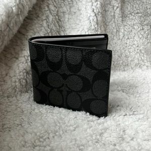 Coach Gray and Black single fold wallet.